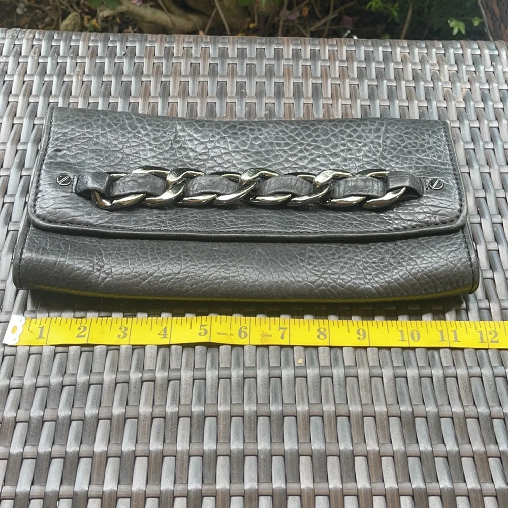 Michael kors Pebbled leather MK clutch with gun metal zipper.